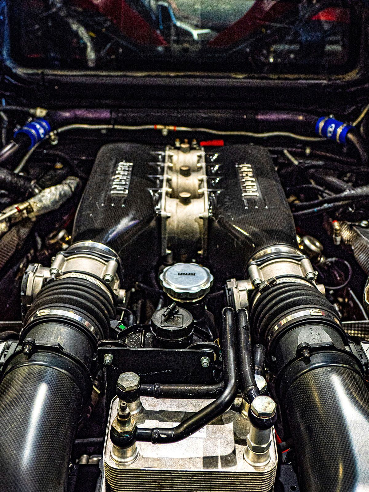 Close-up view of a high-performance car engine with carbon fiber components, showcasing power and engineering.